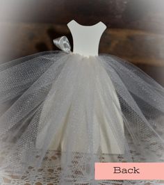 the back of a white tutule with a bow on it