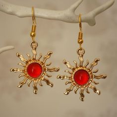 Make a statement with these pretty red sun drop earrings for women. These cool quirky gold plated and acrylic sun earrings are a great way to add a nice touch to your outfit. The charm on these sun dangle earrings measures at 3cm x 2.7cm and is attached to a gold plated hook. Please feel free to get in touch with us at Funky Earrings UK if you have any questions. We also have a wide range of other cute and unusual earrings in our shop. Crazy Earrings Gold, Trendy Gold Sun Design Earrings, Red Metal Earrings For Summer, Trendy Red Metal Earrings, Trendy Sun Design Jewelry, Trendy Red Drop Earrings, Gold And Red Earrings, Magician Outfit, Sun Earring