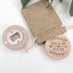 two wooden bottle openers next to a burlock bag and some greenery