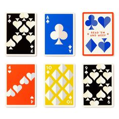 four different colored playing cards with hearts and spades on the front, one in red, one in blue