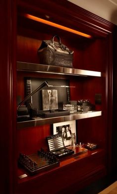 a wooden shelf filled with pictures and other items