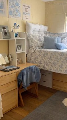 a bed sitting next to a desk in a bedroom under a window on top of a hard wood floor