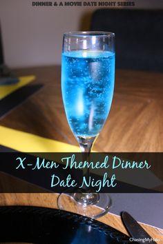 a close up of a wine glass on a table with the words x - men themed dinner date night