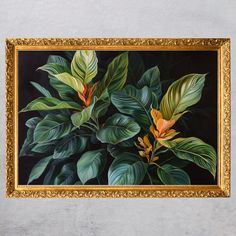 a painting with green and yellow leaves in a gold frame