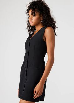 Expertly crafted and designed for a timeless look, the Cressida dress is a mini vest dress that features a solid suiting material, button-up closure, and a flattering v-neck cut. With its versatility and chic design, this dress is perfect for any occasion, making it a wardrobe must-have. Mini button-up vest dress. V-neck cut. Length: 34" 97% polyester 3% elastane. Lilia is 5ft 9in and is wearing a size S. Carla is 5ft 9in and is wearing a size L. Tiered Maxi Skirt, Knit Bottom, Vegan Bags, Love Is Free, Swimwear Sale, Cream Dress, Printed Mini Dress, Floral Midi Dress, Black Mini