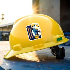 a yellow hard hat sitting on top of a table