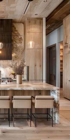 a large kitchen with wooden cabinets and marble counter tops, along with two dining chairs