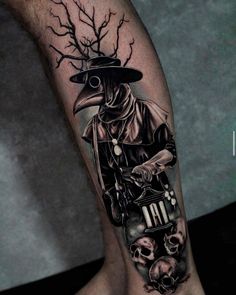 a man's leg with a black and grey tattoo on it, featuring a skull wearing a hat