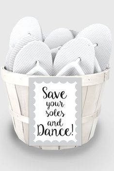 a basket filled with white slippers and a sign that says save your soles and dance