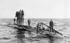 a group of men standing on top of a boat in the middle of the ocean