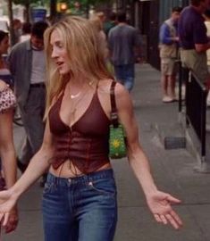 two women are walking down the street with their hands in each other's pockets