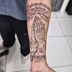 a person with a tattoo on their arm and hand holding the word, i amen