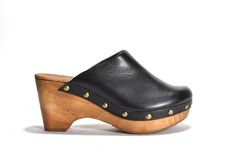 Retro clog on authentic wooded bottom.  Leather lined, rubber outsole.MEASUREMENTS: Heel Height: 3.25 in. Weight: 13 oz. Platform Height: 1.75 in Wooden Mules With Rubber Sole And Round Toe, Casual Wood Mules With Round Toe, Bastad Clogs, Wooden Wedges, Wooden Clogs, Clog Heels, Platform Slippers, Unique Shoes, Clogs Shoes