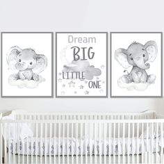 a baby's nursery room with two posters on the wall