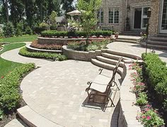 an outdoor patio with stone steps and seating area