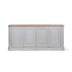 an old white cabinet with three doors