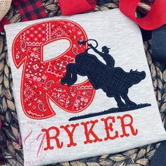 This unique boy's rodeo bull shirt features a bold and stylish design, perfect for any young cowboy! The shirt is made from soft heather gray fabric and is available in both short-sleeved and long-sleeved options. The shirt features the boy's first name initial prominently displayed on the front of the shirt, in a bold, eye-catching red paisley fabric. The boy's full name is also spelled out creating a fun and personalized look. This shirt is perfect for any young cowboy who loves rodeos, bull riding, or just western-style fashion. It's a great choice for casual wear, school events, or even special occasions. The unique design is sure to make any boy feel confident and stylish, while also showing off his individuality and personality. Care Instructions: - machine wash, gentle cycle inside Rodeo Bull Riding, Rodeo Bull, Bulls Shirt, Cowboy Rodeo, Rodeo Shirts, Shirt For Boys, Paisley Fabric, Bull Riding, Red Paisley