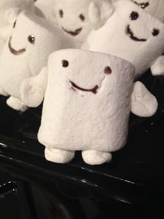 there are many marshmallows with faces on them