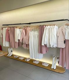 clothes and shoes are on display in a clothing store