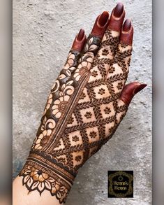 a woman's hand with henna on it