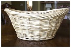 a white basket sitting on top of a wooden table