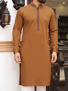 <ul> <li>Color: Copper</li> <li>Gorgeous kurta features delicate printed fabric details on placket and collar*</li> <li>Complemented with white Pajama</li> </ul> <p><small>*Exact printed fabric on placket and collar is subject to availability</small> <br /><br /><strong>Additional Accessories:</strong><br />Peshawari Sandal / Khussa: <strong>US$50</strong></p> Eid Kurta, Kamiz Design, Pakistani Wear, Man Dress Design, Junaid Jamshed, Boys Kurta Design, Groom Dress Men, Fashion Models Men, Gents Kurta Design