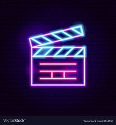 a neon movie clapper on a brick wall