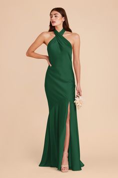 a woman in a long green dress with a slited skirt and high slits