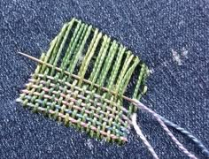 a close up of a piece of cloth with some knitting needles