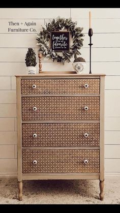 an old dresser has a wreath on top