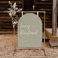 a sign that says lucky richard on it with flowers in front of a wooden building