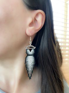 a close up of a person wearing some kind of earrings