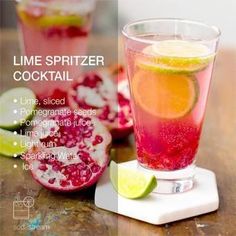 a drink with lime, sliced pomegranate and lemon