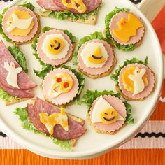 a white plate topped with lots of food on top of a table