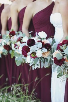 the bridesmaids are holding their bouquets with red and white flowers