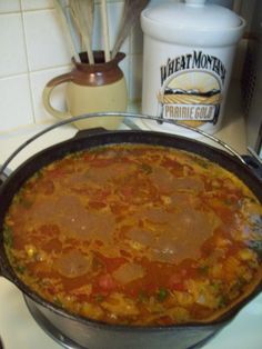 a large pot filled with food sitting on top of a stove