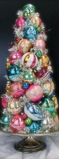 a christmas tree made out of ornaments on top of a silver plated platter