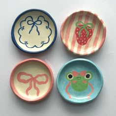 four plates with different designs on them