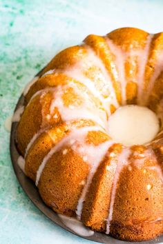 a bundt cake sitting on top of a pan covered in glaze and icing