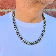 "If you want a quality chain with solid construction, look no further.  This is a 14mm wide, Stainless Steel Cuban Link Curb Chain with a secure and easy to use lobster clasp closure.  This design features a Stainless Steel Curb Chain that is taken through a series of processes to give this unique look. It is polished, blackened and then matted to make this the statement piece in your collection.  This is the widest of my curb chains. I have a picture listed for you to compare the different widths. The Cuban Link Chain Collection has matching bracelets and gold and black stainless finishes as well. Be sure to check out the complete line here: https://etsy.me/31wBRXB S I Z E Width: 14mm  Length: 20\", 22 and 24\" please choose from menu  Thickness: 7mm 316L Stainless Steel All chains are cu Silver Cuban Link Necklace, Everyday Silver Cuban Link Necklace, Stainless Steel Cuban Link Box Chain Necklace, Stainless Steel Chain Link Necklace, Classic Cuban Link Stainless Steel Necklace, Tarnish-resistant Cuban Link Metal Chain Necklace, Luxury Men’s Cuban Link Necklace With Curb Chain, Luxury Tarnish-resistant Cuban Link Necklace For Men, Miami Cuban Link Chain