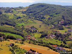 an aerial view of a small village in the middle of a valley surrounded by mountains