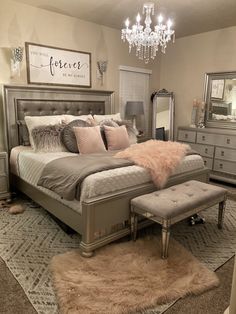 a bedroom with a bed, dressers and a chandelier hanging from the ceiling