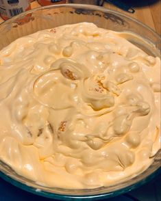 a bowl filled with cream sitting on top of a table