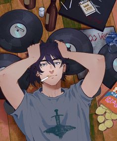 a man laying on the floor with his head in his hands, surrounded by records