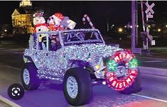 a jeep decorated for christmas driving down the street