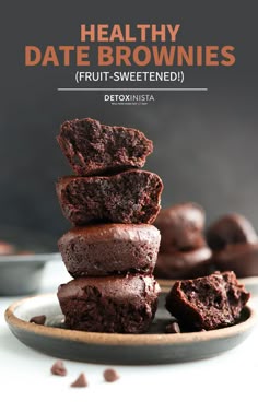 chocolate brownies stacked on top of each other in a plate with text overlay that reads healthy date brownies fruit - sweetened