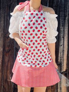 a mannequin dressed in an apron and strawberries on it's shoulder