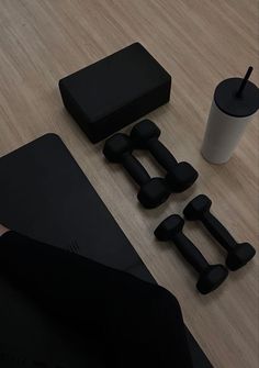 black objects are sitting on the floor next to a coffee cup