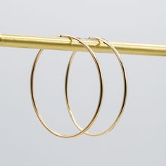 A Bold-But-Subtle Design: The 14k Gold Filled 40mm Endless Hoop Pair. This classic and trendy hoop will be your daily go to. The thickness of the 14k gold filled is 1mm and the diameter of the hoops is approximately 1.5". Lightweight for all day wear. All Jewel Ya hoops are designed to fit over 100 gemstone, pearl and fine metal drops. Change your earrings daily by adding a new set of hoop drops. Every Jewel Ya design arrives in our signature acrylic container for airtight storage. 14k Gold-filled Tarnish-resistant Hoop Earrings, 14k Gold Filled Tarnish Resistant Hoop Earrings, Tarnish Resistant 14k Gold Filled Hoop Earrings, Elegant 14k Gold Filled Circle Hoop Earrings, Hypoallergenic Gold Plated Hoop Earrings, 14k Yellow Gold Filled Hoop Earrings, Hypoallergenic 14k Gold Hoop Earrings, Dainty Yellow Gold Hoop Earrings, Modern 14k Gold Filled Hoop Earrings