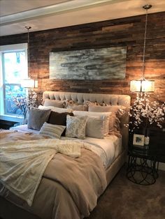 a large bed sitting in a bedroom next to a window with wooden panels on the wall